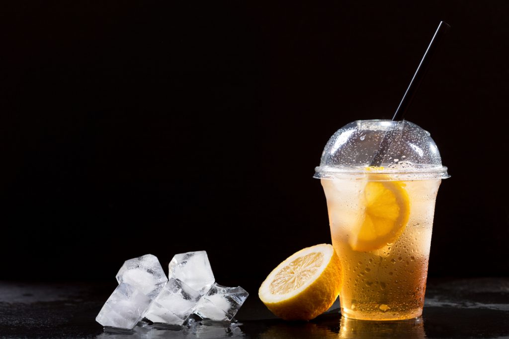 cold ice lemon tea ice cubes black background 