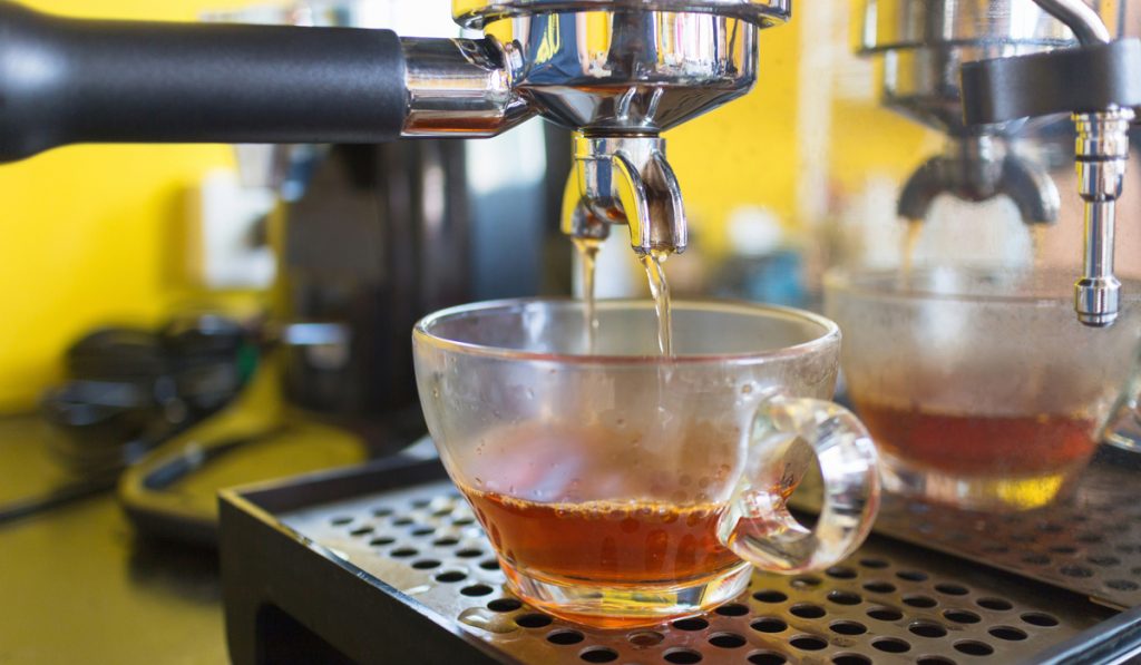 espresso machine pouring hot tea glass cap