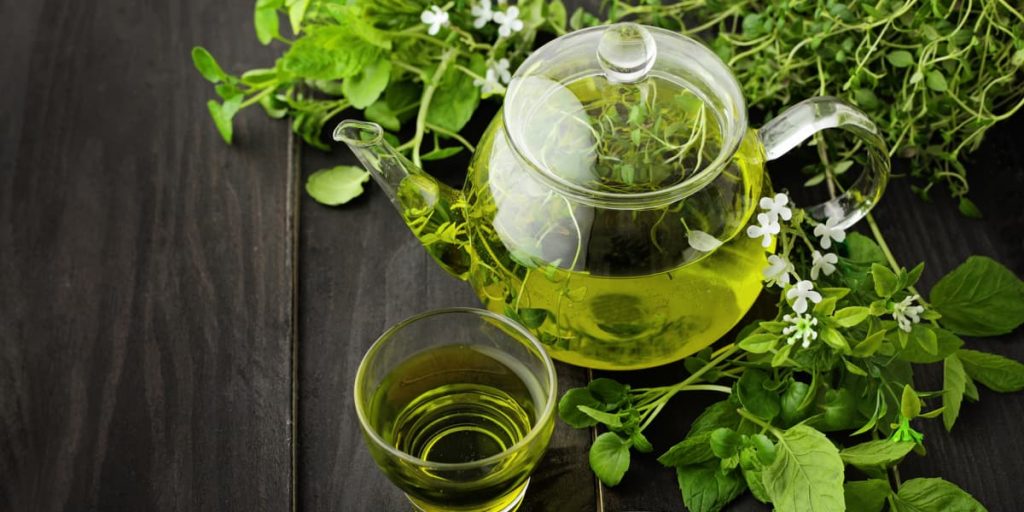 healthy green tea cup with tea leaves
