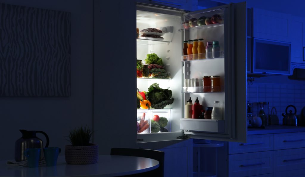 open refrigerator full products kitchen night view 