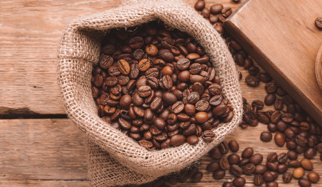 whole coffee bean bag wooden background 